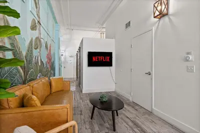 a living room with a couch and a table at Downtown Gaslamp Getaway Stylish 4BR APT in San Diego