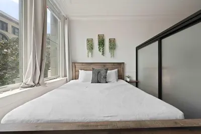 a bedroom with a large bed and a window at Central Downtown Apt Sleeps 8 & Enjoy Gaslamp in San Diego