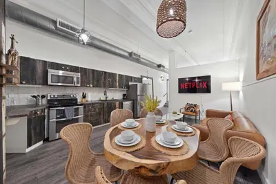a kitchen and dining room with a wooden table and chairs at Central Downtown Apt Sleeps 8 & Enjoy Gaslamp in San Diego