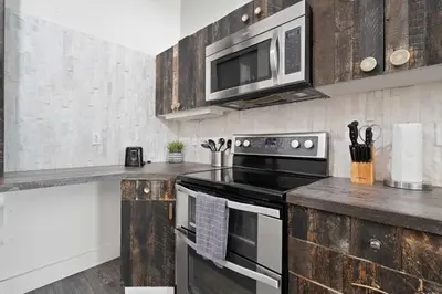 a kitchen with a stove and a microwave at Central Downtown Apt Sleeps 8 & Enjoy Gaslamp in San Diego