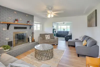 a living room with a couch and a fireplace at Waterfront Getaway on Lake Elsinore with Swim Spa in Lake Elsinore