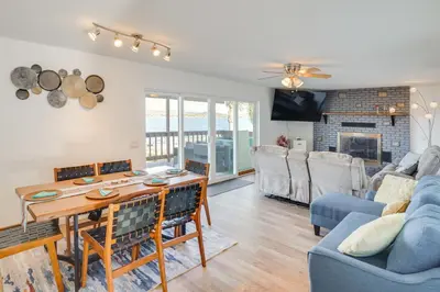a living room with a table and a couch at Waterfront Getaway on Lake Elsinore with Swim Spa in Lake Elsinore