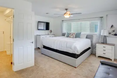 a bedroom with a white bed and a window at Waterfront Getaway on Lake Elsinore with Swim Spa in Lake Elsinore