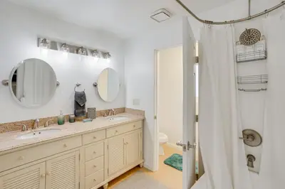 a bathroom with a double sink and a shower at Waterfront Getaway on Lake Elsinore with Swim Spa in Lake Elsinore