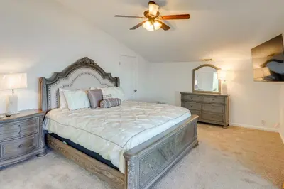 a bedroom with a large bed and a ceiling fan at Waterfront Getaway on Lake Elsinore with Swim Spa in Lake Elsinore
