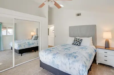 a bedroom with a bed and a mirror at Waterfront Getaway on Lake Elsinore with Swim Spa in Lake Elsinore