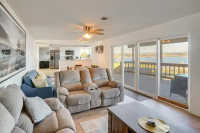 a living room with two couches and a table at Waterfront Getaway on Lake Elsinore with Swim Spa in Lake Elsinore