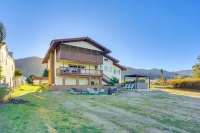 a house with a large yard in front of it at Waterfront Getaway on Lake Elsinore with Swim Spa in Lake Elsinore