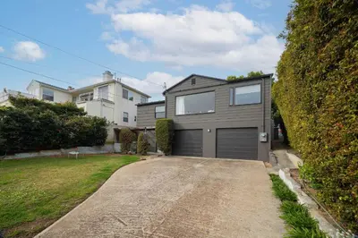 a house with a garage in a driveway at Water & Downtown Views Close to beach Villa in San Diego