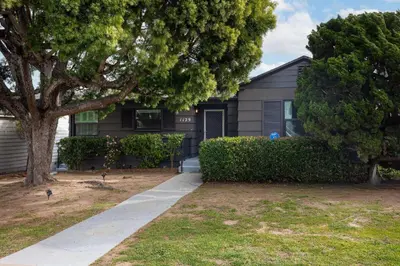 a house with a tree in front of it at Water & Downtown Views Close to beach Villa in San Diego