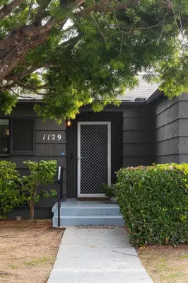 a black house with a blue porch and a door at Water & Downtown Views Close to beach Villa in San Diego