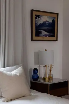 a bedroom with a bed and a table with a lamp at Water & Downtown Views Close to beach Villa in San Diego