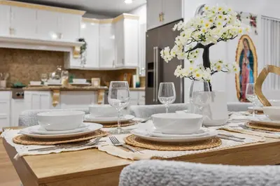 a dining room table with plates and wine glasses at Entire Private Home with 4 Bedrooms 2 Bathrooms, Pool, View, 4 Parking, King Bed, Big Yard, Available Now in El Cajon