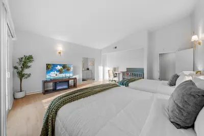 a bedroom with two beds and a flat screen tv at Entire Private Home with 4 Bedrooms 2 Bathrooms, Pool, View, 4 Parking, King Bed, Big Yard, Available Now in El Cajon
