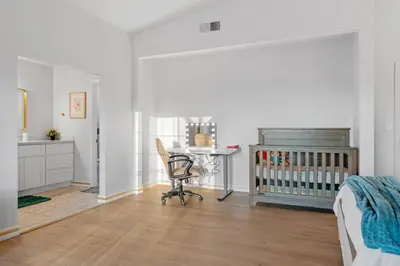 a bedroom with a crib and a chair and a desk at Entire Private Home with 4 Bedrooms 2 Bathrooms, Pool, View, 4 Parking, King Bed, Big Yard, Available Now in El Cajon