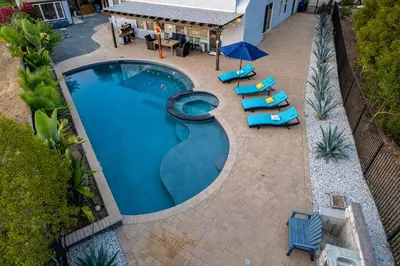 an overhead view of a swimming pool with chairs and umbrellas at Entire Private Home with 5 Bedrooms 4 Bathrooms 3000 Sq ft Villa, Pool, Hot Tub, Nature, Garage, Winery, Available Now in Fallbrook