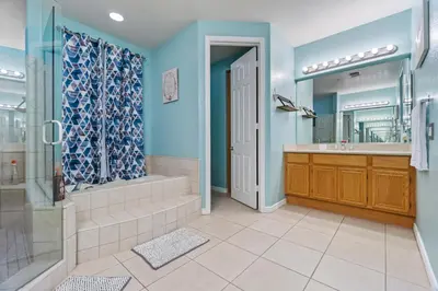 a bathroom with a shower and a tub and a sink at Entire Private Home with 5 Bedrooms 4 Bathrooms 3000 Sq ft Villa, Pool, Hot Tub, Nature, Garage, Winery, Available Now in Fallbrook
