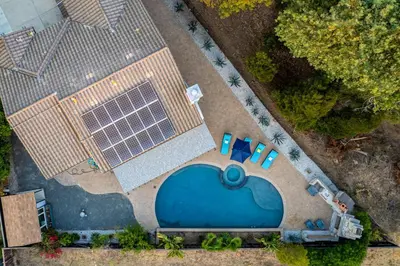 an overhead view of a swimming pool with a solar array at Entire Private Home with 5 Bedrooms 4 Bathrooms 3000 Sq ft Villa, Pool, Hot Tub, Nature, Garage, Winery, Available Now in Fallbrook