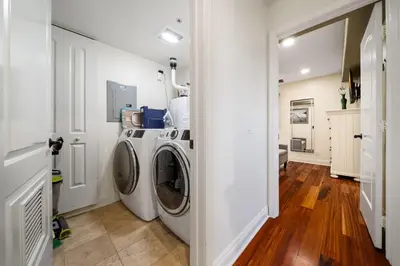 a white laundry room with a washer and dryer at Steps to Sand - Pacific Beach 3BR Townhome in San Diego