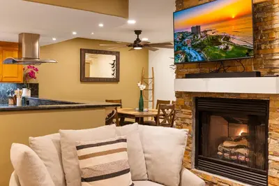 a living room with a fireplace and a tv at Steps to Sand - Pacific Beach 3BR Townhome in San Diego