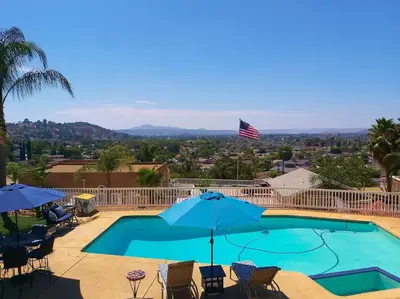 a swimming pool with chairs and umbrellas at Stylish Relaxation-Panoramic Views-Private OASIS in El Cajon