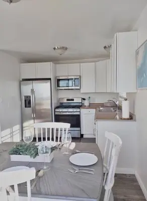 a kitchen with a table and chairs and a kitchen with white cabinets at Stylish Relaxation-Panoramic Views-Private OASIS in El Cajon