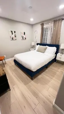 a bedroom with a large bed and a wooden floor at 321 W Park 2Bed 1Bath Unit A by SD Stay in El Cajon