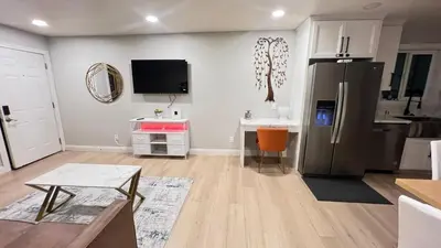 a living room with a black refrigerator and a kitchen at 321 W Park 2Bed 1Bath Unit A by SD Stay in El Cajon