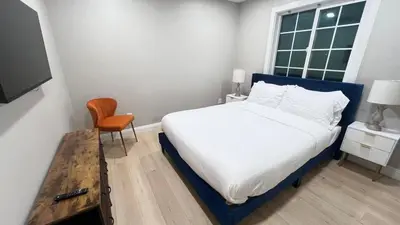 a bedroom with a bed and a chair and a window at 321 W Park 2Bed 1Bath Unit A by SD Stay in El Cajon