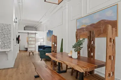 a living room with a wooden table and a couch at Party in Gaslamp 4BR Downtown Pad with Bathtub in San Diego