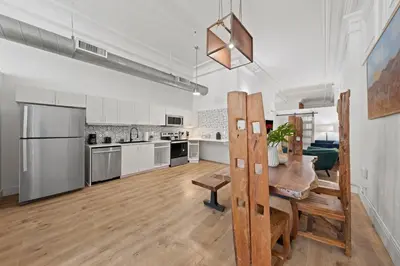 a large kitchen and dining room with a table in it at Party in Gaslamp 4BR Downtown Pad with Bathtub in San Diego