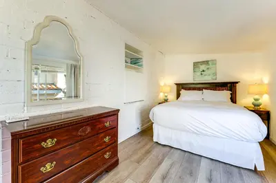a bedroom with a bed and a dresser and a mirror at Private Hilltop Getaway with Patio Dogs Welcome! in Vista