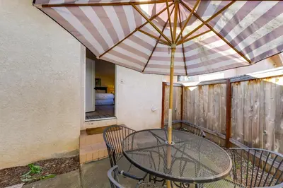 a table and chairs with an umbrella on a balcony at Private Hilltop Getaway with Patio Dogs Welcome! in Vista