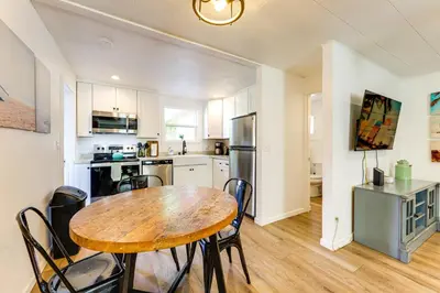 a kitchen and dining room with a wooden table and chairs at Private Hilltop Getaway with Patio Dogs Welcome! in Vista