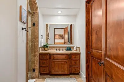 a bathroom with a sink and a mirror at Sunset Point Estate in Poway