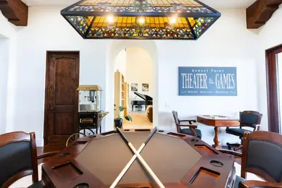 a ping pong table in a room with a chandelier at Sunset Point Estate in Poway