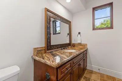 a bathroom with a sink and a mirror at Sunset Point Estate in Poway