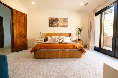 a bedroom with a bed and a large window at Sunset Point Estate in Poway