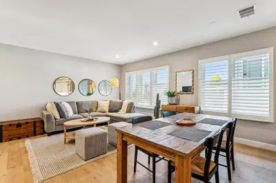 a living room with a table and a couch at Walk to Pier and Downtown San Clemente Rooftop Deck in San Clemente