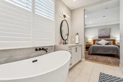 a bathroom with a tub and a bedroom with a bed at Walk to Pier and Downtown San Clemente Rooftop Deck in San Clemente