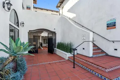 a house with a staircase leading to a door at Walk to Pier and Downtown San Clemente Rooftop Deck in San Clemente