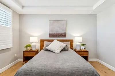 a bedroom with a large bed with two lamps at Walk to Pier and Downtown San Clemente Rooftop Deck in San Clemente