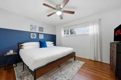 a bedroom with a bed with a ceiling fan at 3BR Modern Chula Vista Home with Hot Tub and Game Room in Chula Vista