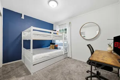 a bedroom with a white bunk bed and a desk at 3BR Modern Chula Vista Home with Hot Tub and Game Room in Chula Vista