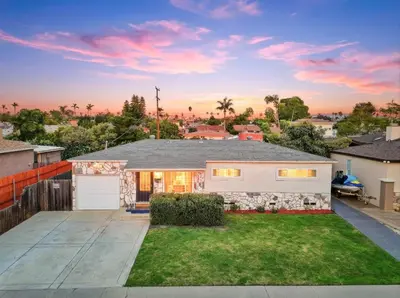 a large white house with a yard at 3BR Modern Chula Vista Home with Hot Tub and Game Room in Chula Vista
