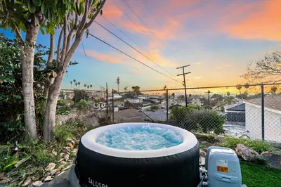 a large bath tub sitting in a yard with a tree at Entire Private Home with 1 Bedroom, 1 Bathroom, King Bed, Hot Tub, Parking, View, Available Now in San Diego
