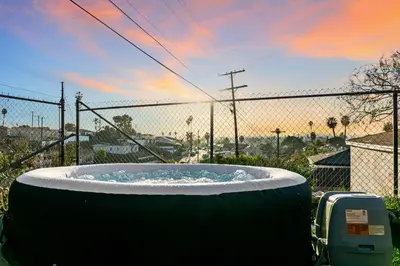 a large hot tub in front of a fence at Entire Private Home with 1 Bedroom, 1 Bathroom, King Bed, Hot Tub, Parking, View, Available Now in San Diego