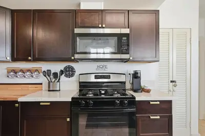 a kitchen with a stove and a microwave at NEW Oceanfront Luxury Christian RARE Single Family Home in San Diego