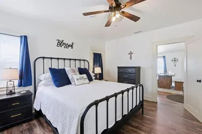a bedroom with a bed and a ceiling fan at NEW Oceanfront Luxury Christian RARE Single Family Home in San Diego