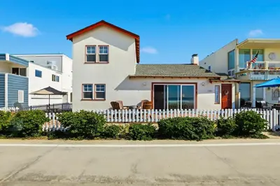 a white house with a white picket fence at NEW Oceanfront Luxury Christian RARE Single Family Home in San Diego